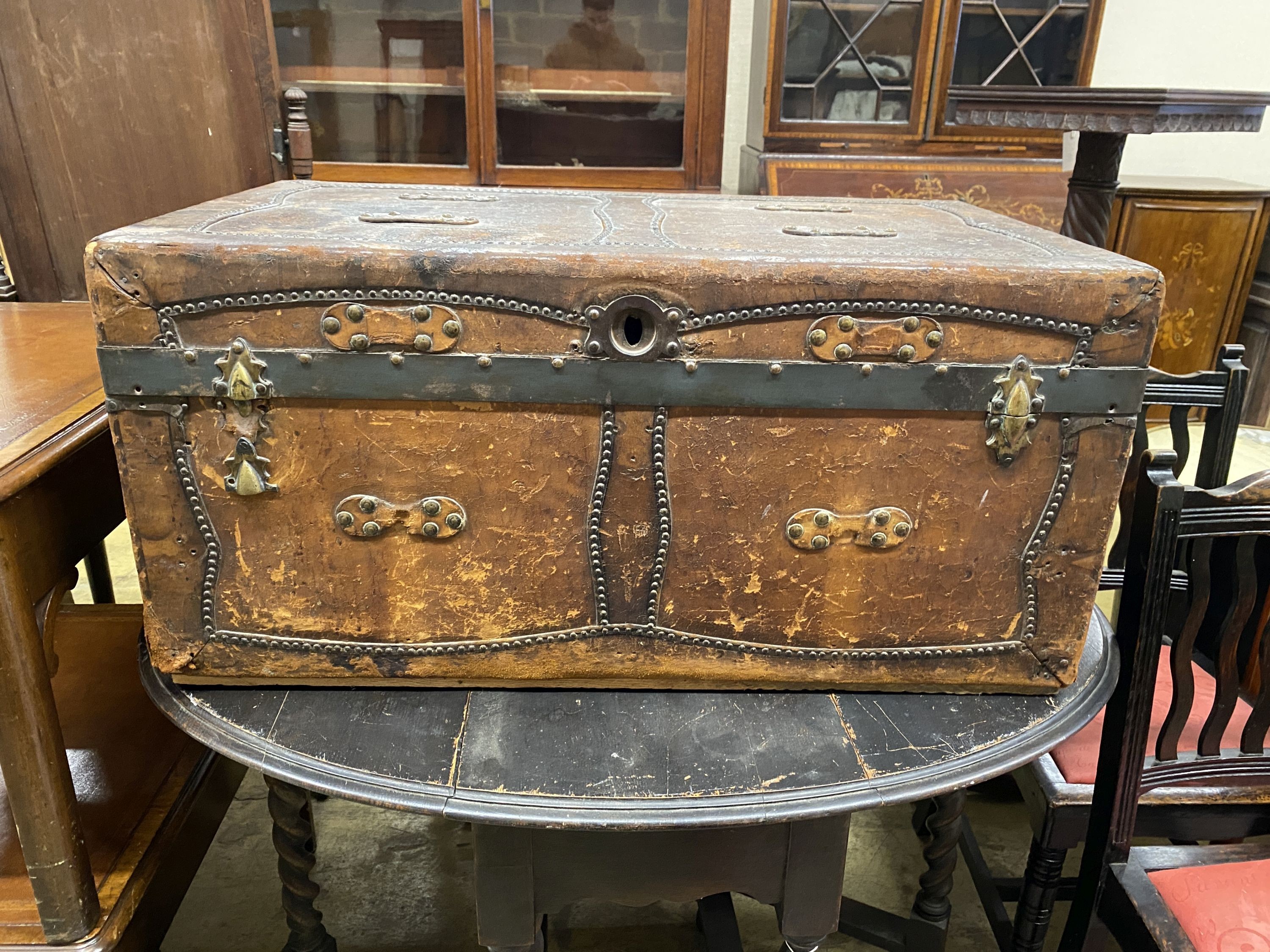 A 19th century studded brown leather covered trunk, length 87cm, depth 51cm, height 41cm